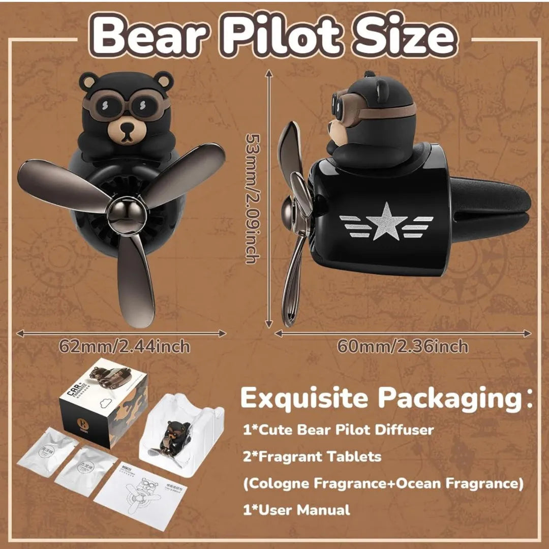 Bear pilot-themed car air freshener, featuring dimensions and packaging details. The package includes a cute bear pilot diffuser, two fragrant tablets (Cologne and Ocean fragrances), and a user manual. The diffuser measures 62mm x 53mm x 60mm.