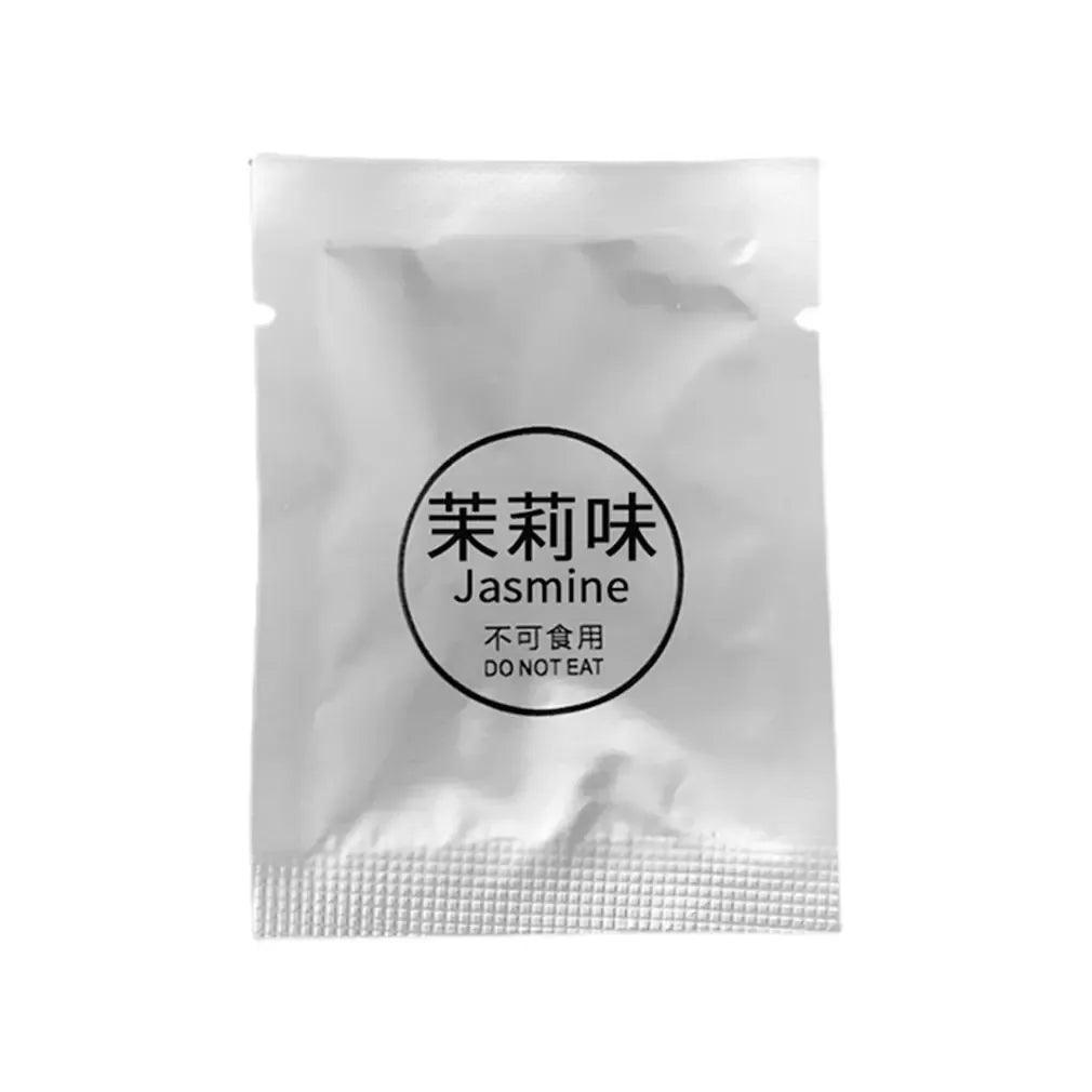 Individually packaged air freshener with a jasmine scent in a silver foil packet labeled 'Jasmine' with a warning 'DO NOT EAT'.