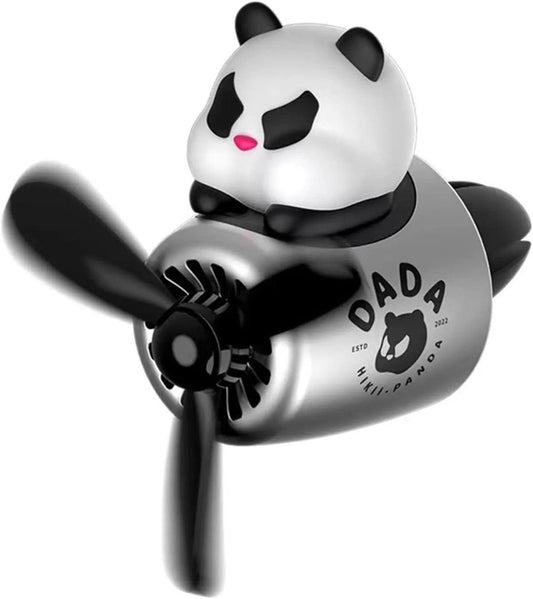 A car air freshener featuring a cute panda figure sitting on top of a silver and black airplane-shaped body with a propeller in the front. The text on the body reads 'DADA' with a panda logo and 'ESTD 2022'.