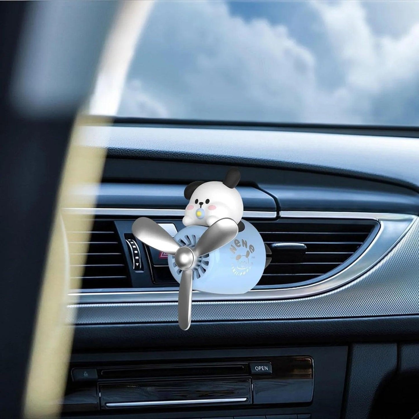 Dog Pilot Car Air Freshener with Propeller Diffuser attached to car air vent, close-up view.