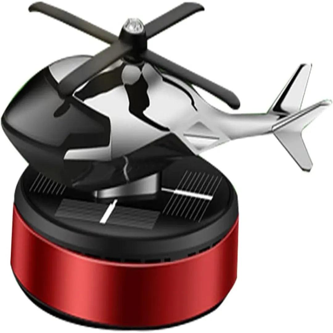 Red and black solar-powered helicopter propeller car air freshener on a circular base, perfect for enhancing automobile interior aesthetics and providing a fresh fragrance.