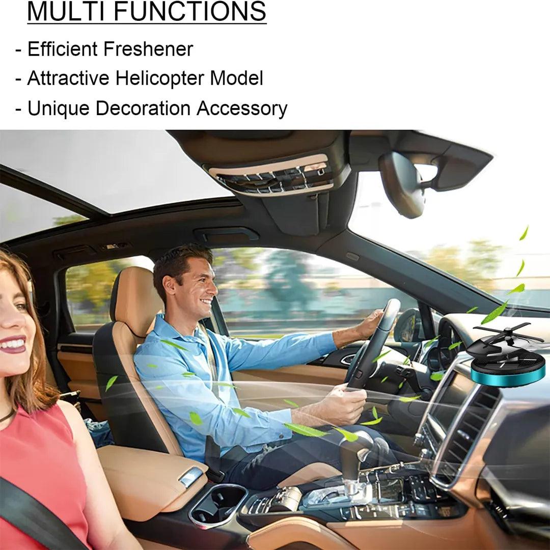 Couple enjoying a drive with a solar-powered helicopter propeller car air freshener on the dashboard, highlighting its multifunctionality as an efficient freshener, attractive model, and unique decoration accessory.