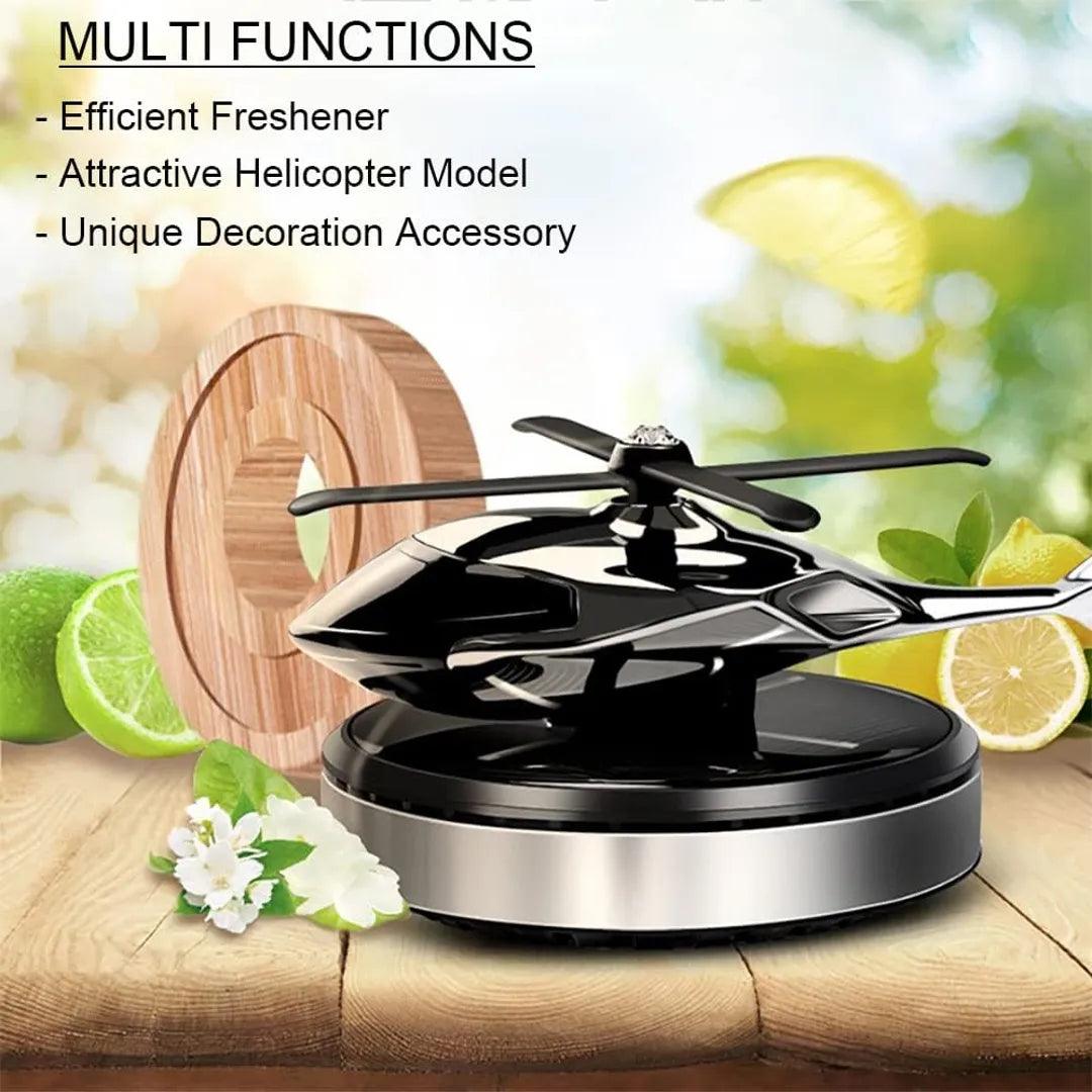 Solar-powered helicopter propeller car air freshener in black and silver, showcased with lime and floral elements, highlighting its multifunctionality as an efficient freshener, attractive model, and unique decoration accessory.