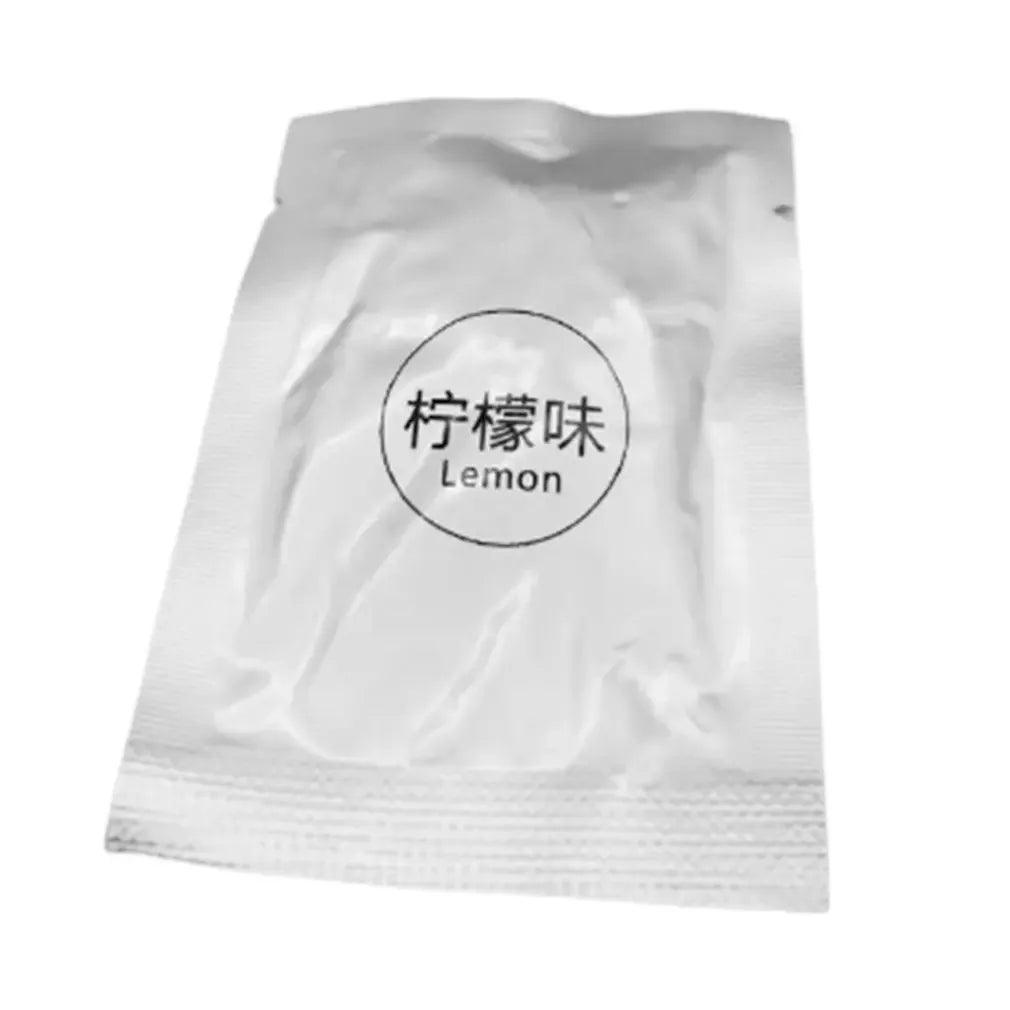 Individually packaged air freshener with a lemon scent in a silver foil packet labeled 'Lemon'.